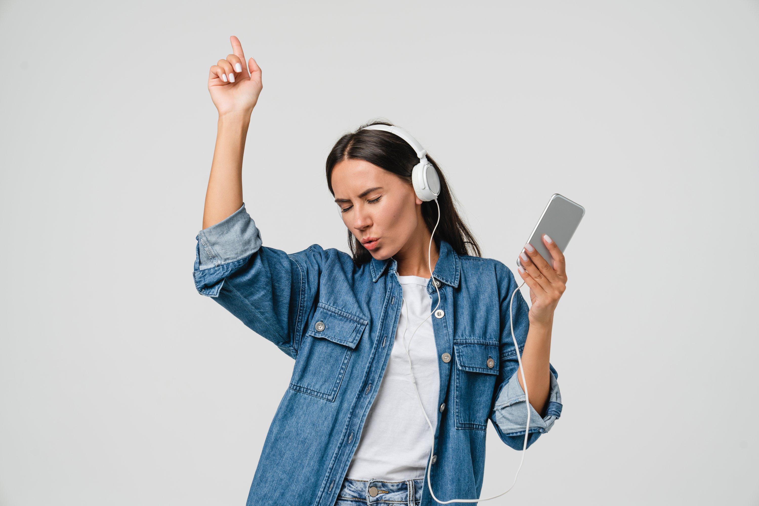 A person dancing while listening to music on headphones.
