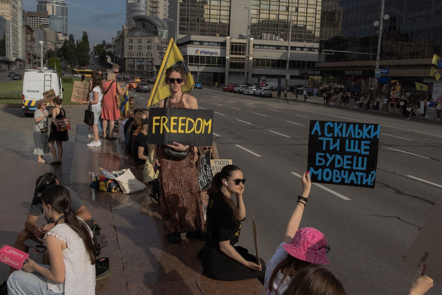 Campaigners stand along a road holding placards during a rally to raise awareness to the fate of Ukrainian POW, in Kyiv, Ukraine, on Aug. 10, 2025.
