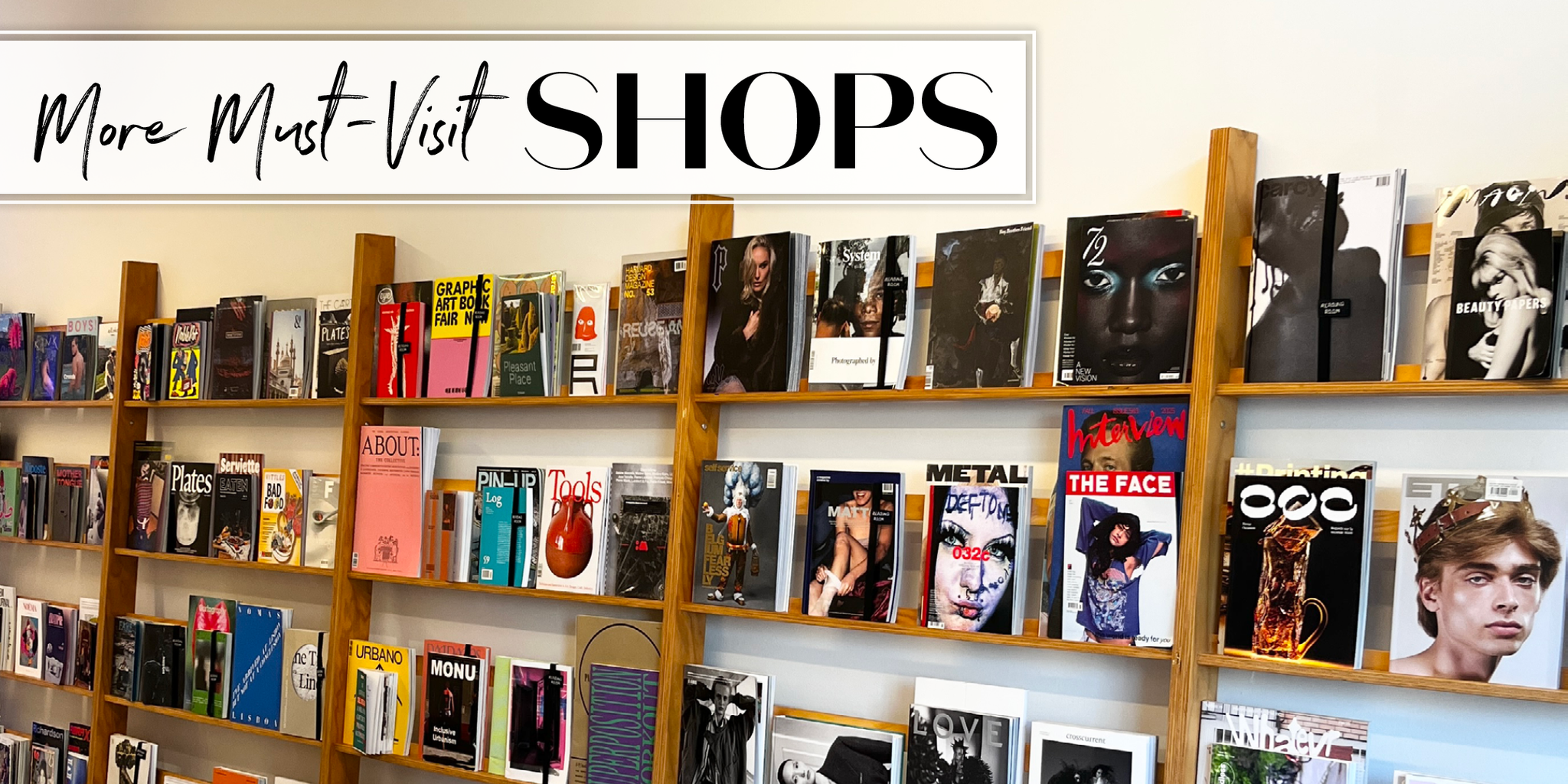 Display of various magazines on wooden shelves in a shop.