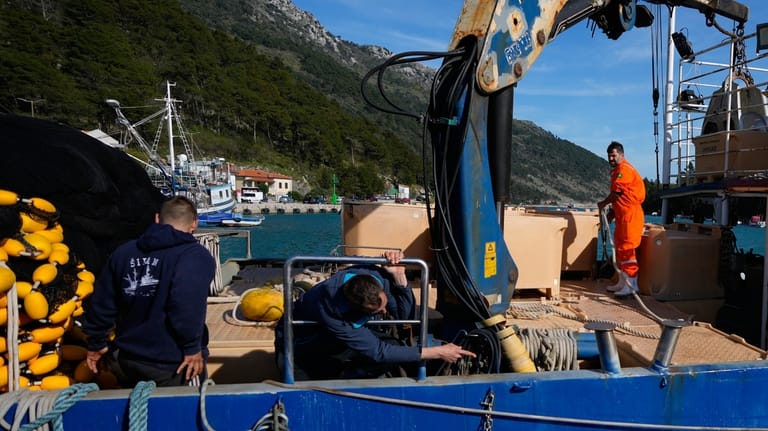 Fishermen prepare to depart for fishing in the port of...