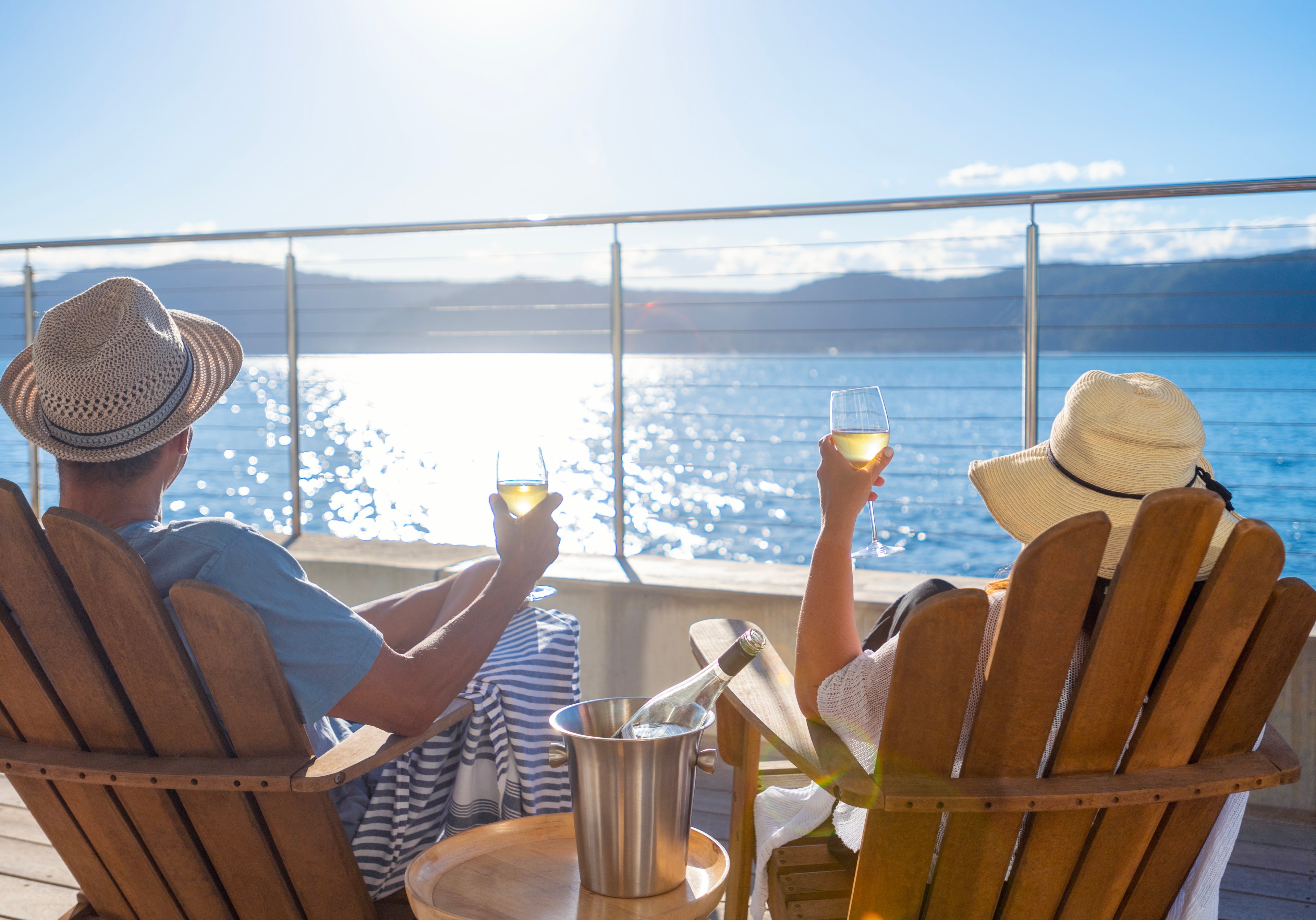 A couple watches a sunset from a cruise ship.