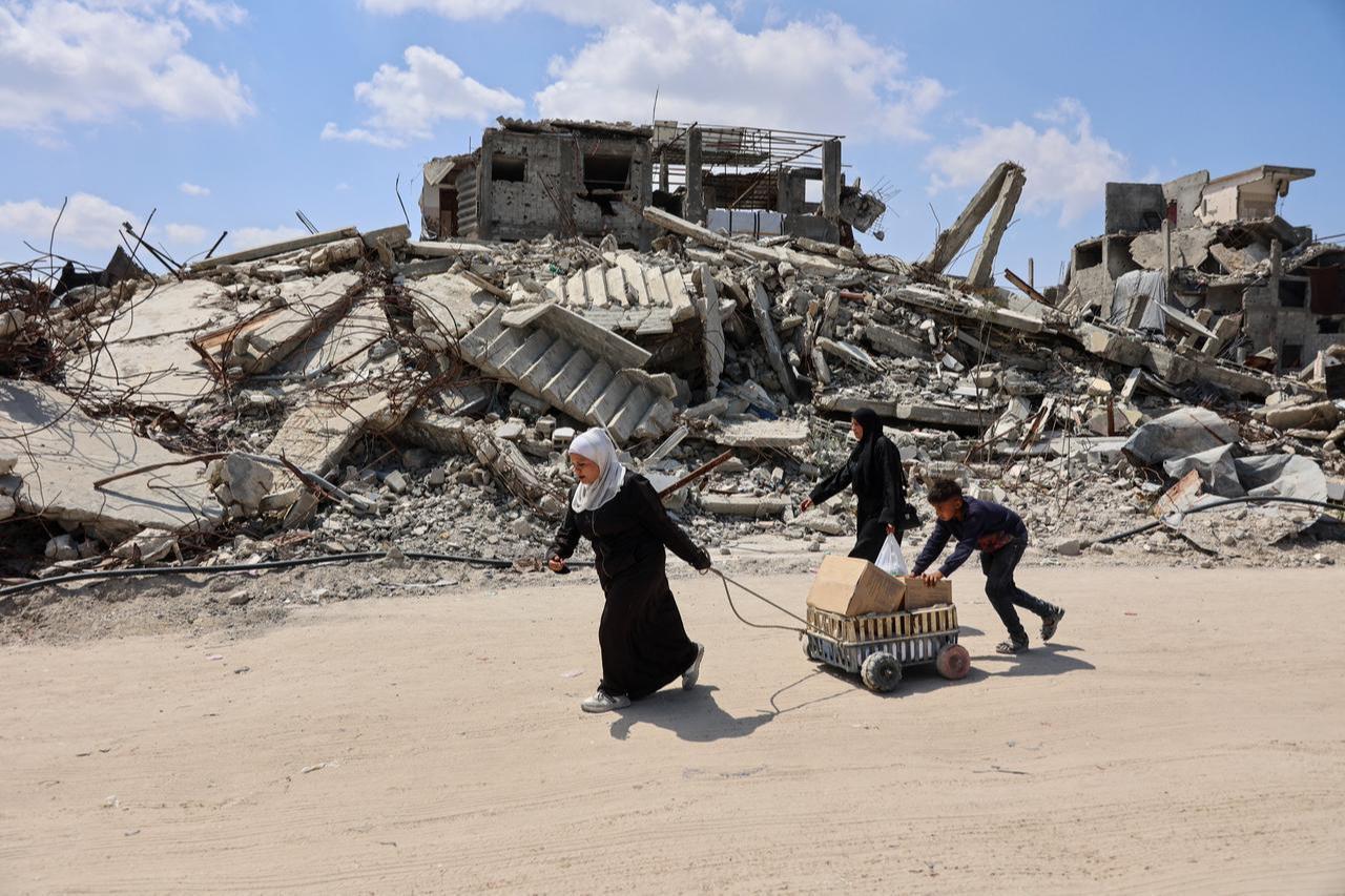 Displaced Palestinians carry boxes in a cart past the rubble of destroyed buildings at the Jabalia refugee camp in the northern Gaza Strip on April 13, 2026. (AFP Photo)