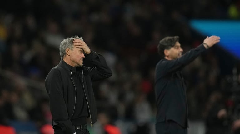 PSG's head coach Luis Enrique, left, reacts during the French...
