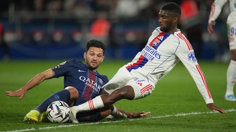 PSG's Goncalo Ramos, left, and Lyon's Clinton Mata challenge for...