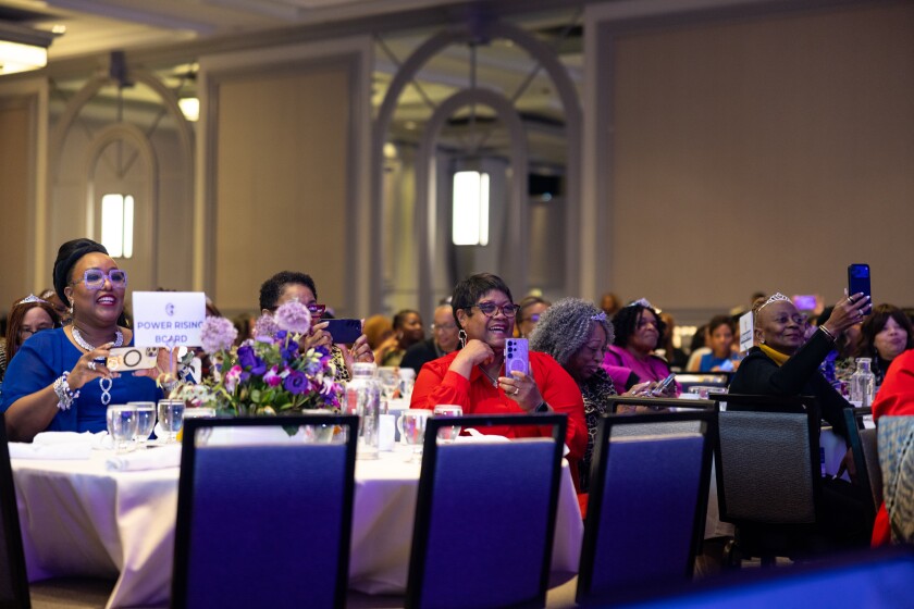 Attendees cheer for former Vice President Kamala Harris during “Power Rising,” a summit for Black women empowerment.