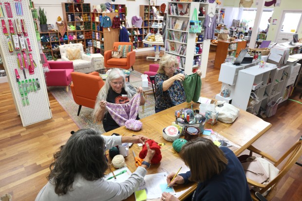 (Clockwise from left) Janice Orrego, Elisa Snedden, Tammy Montenegro, and Liz Schuiling knit and crochet at a drop-in session at Purls of Joy in Healdsburg Thursday, April 16, 2026. (Beth Schlanker / The Press Democrat)