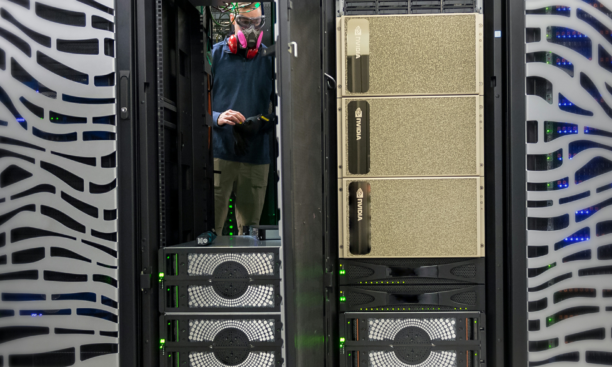 Person standing inside a data center with Nvidia chips.