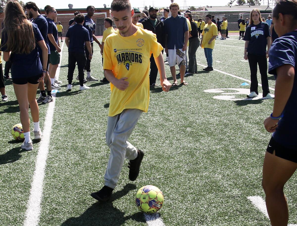Dylan Scott, 15, plays soccer against an athlete from Westcliff University in Huntington Beach on Thursday.