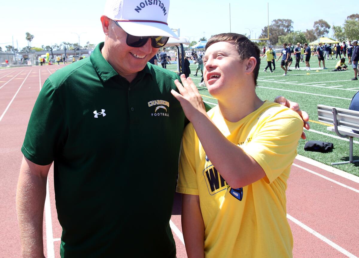 Joe Loomis has fun with special education student Chase Ream on Thursday.