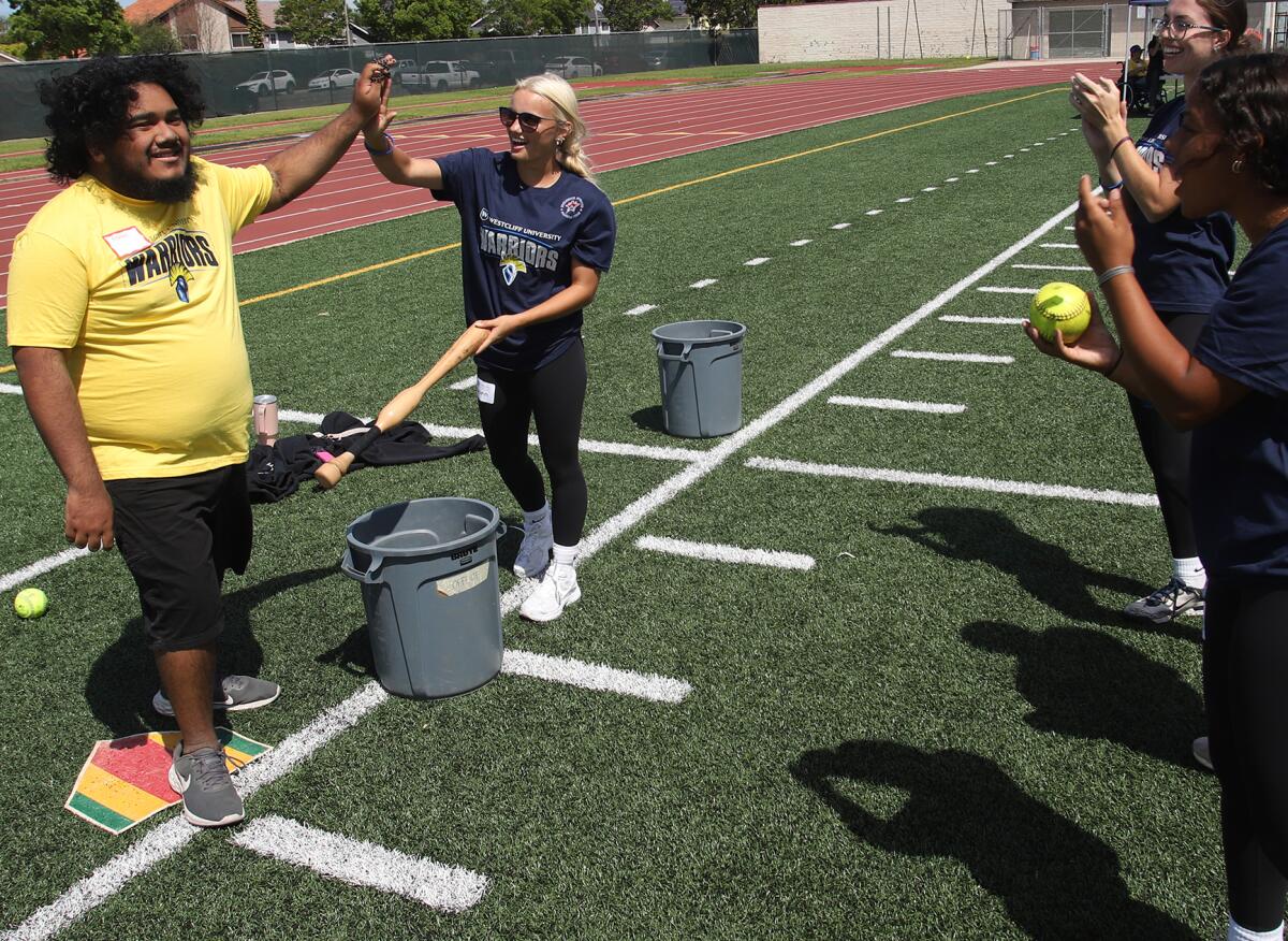 A special education student from the Huntington Beach Union High School District gets a high-five.