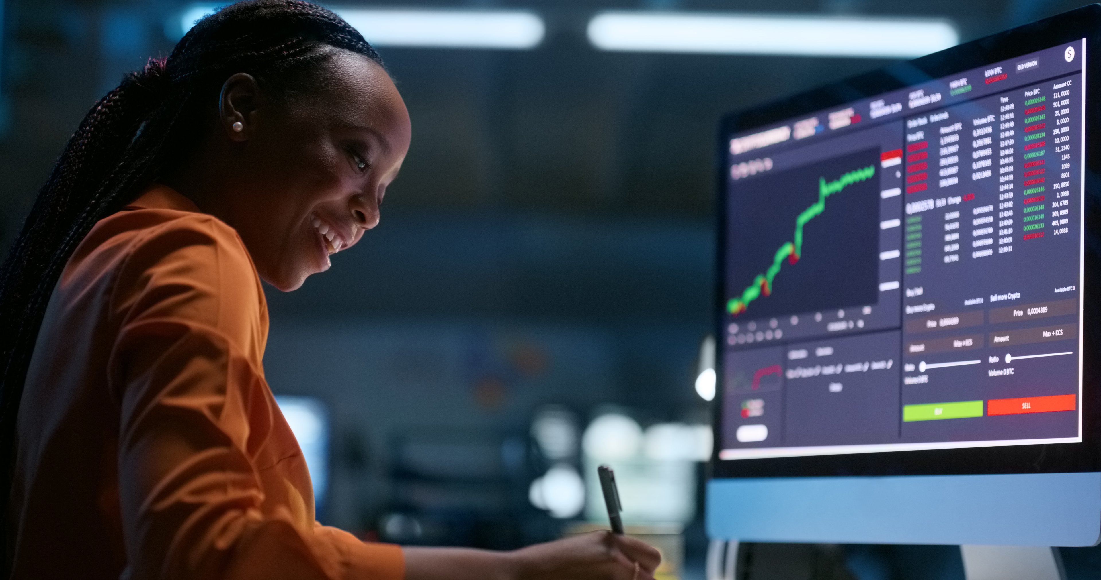 A person smiling while watching a stock chart rise.