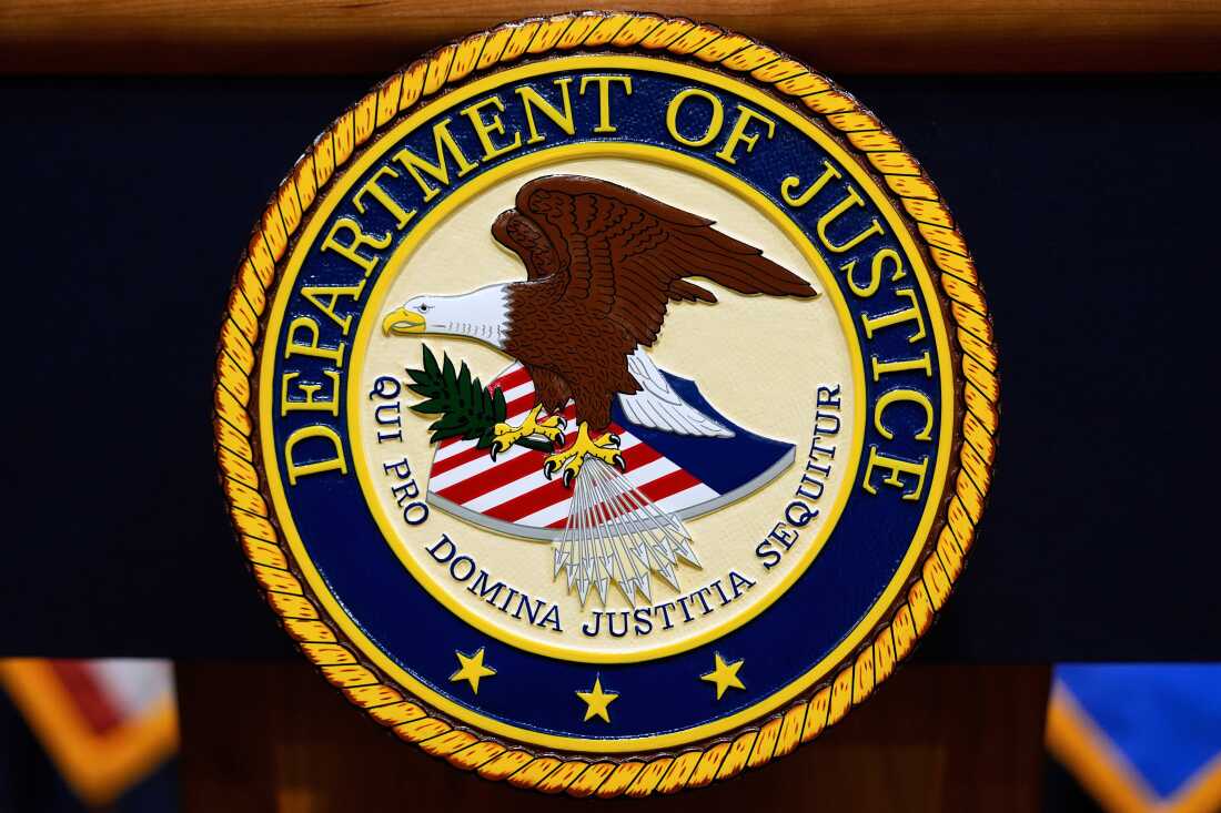 The U.S. Department of Justice logo is seen on a podium before a news conference at the Justice Department in Washington, on May 6, 2025.
