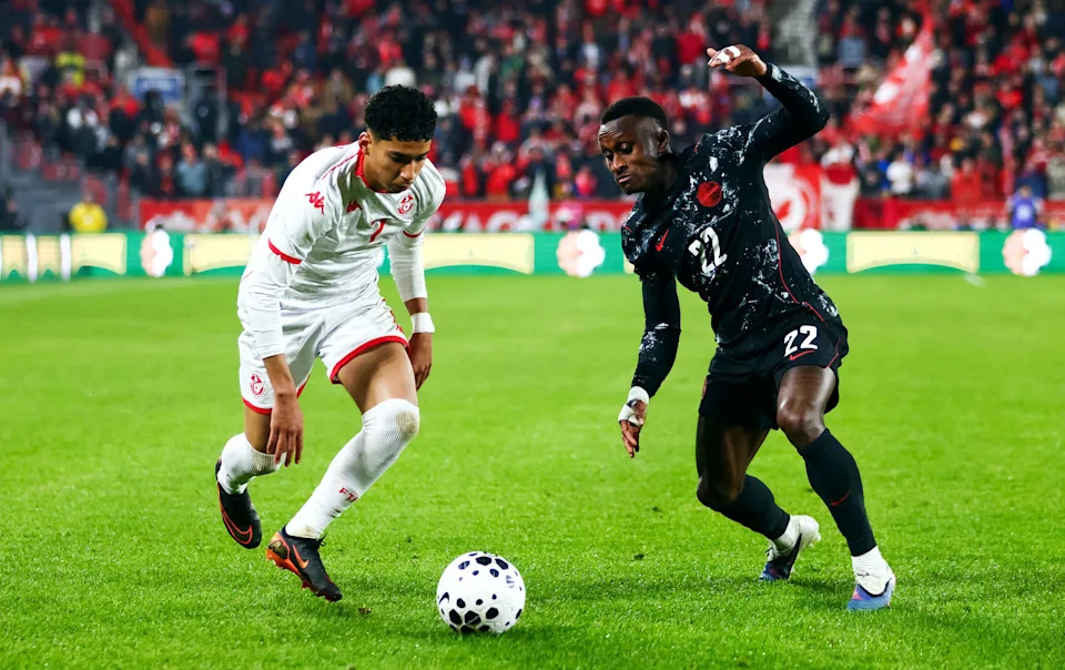 Soccer Football - International Friendly - Canada v Tunisia - BMO Field, Toronto, Canada - March 31, 2026 Tunisia's Khalil Ayari in action with Canada's Richie Laryea REUTERS/Cole Burston