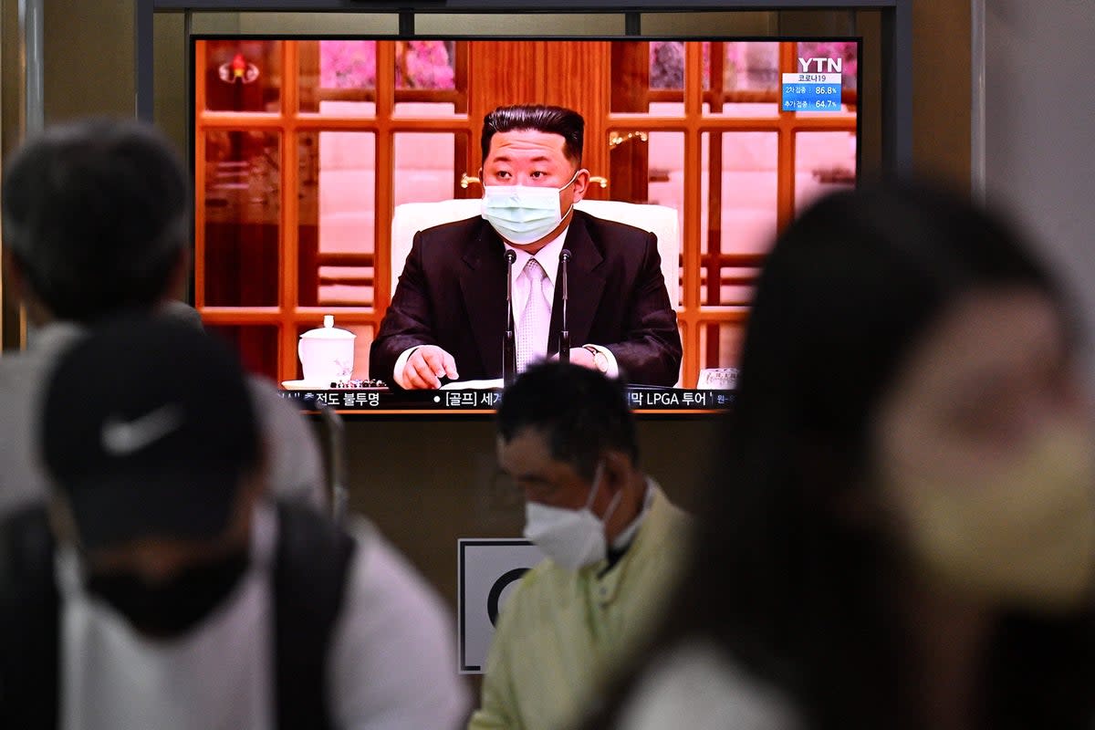 North Korea's leader Kim Jong Un appearing in a face mask on television for the first time to order nationwide lockdowns after the North confirmed its first-ever Covid-19 cases (AFP via Getty Images)