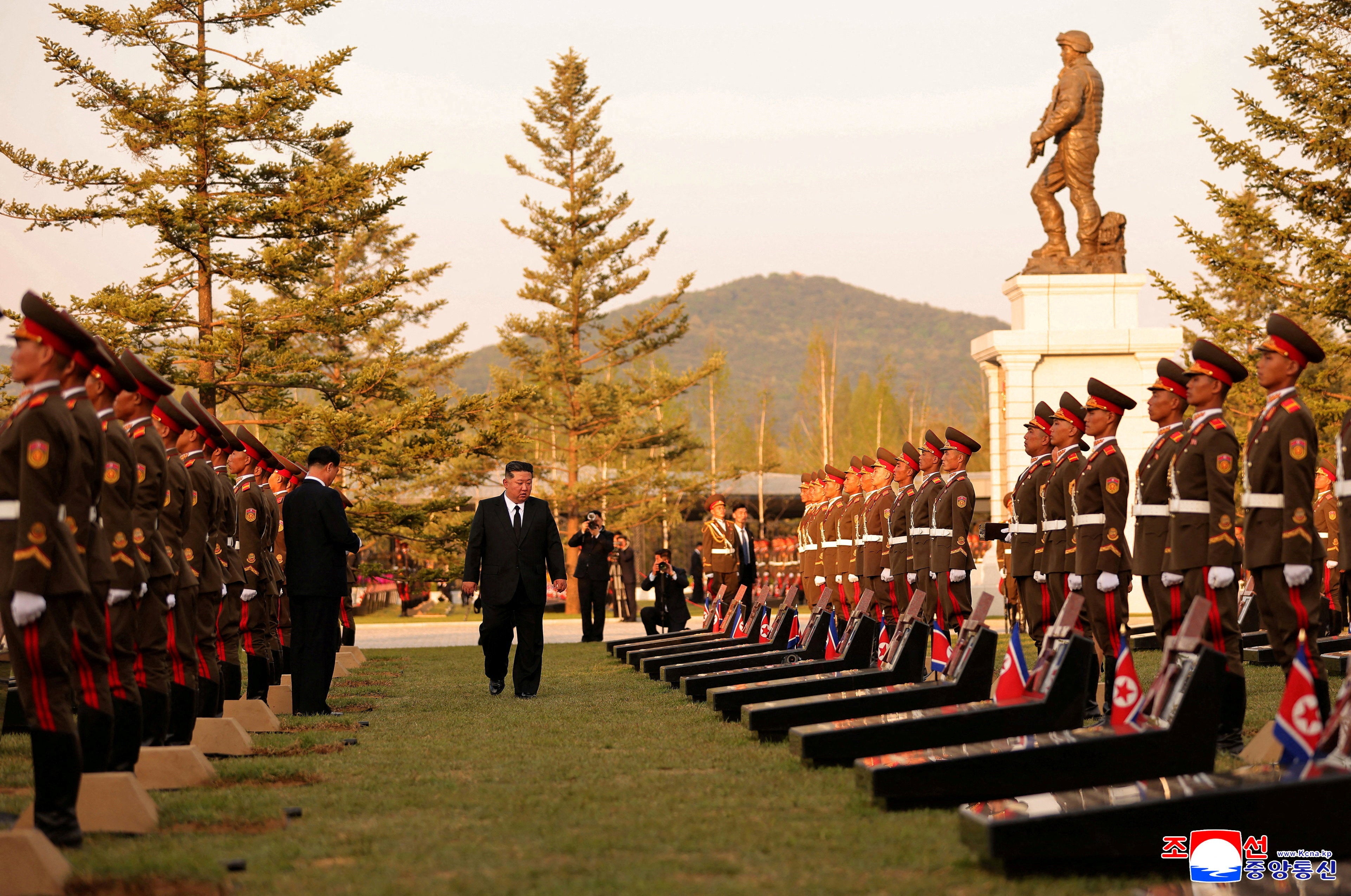 North Korean leader Kim Jong Un walks next to memorial stones during the opening ceremony of the Memorial Museum of Combat Feats