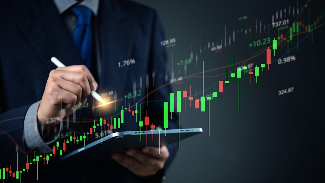 Close-up of hand using stylus on stock market chart on tablet. Ideal for stock trading, investment analysis, financial planning, and business growth concepts.