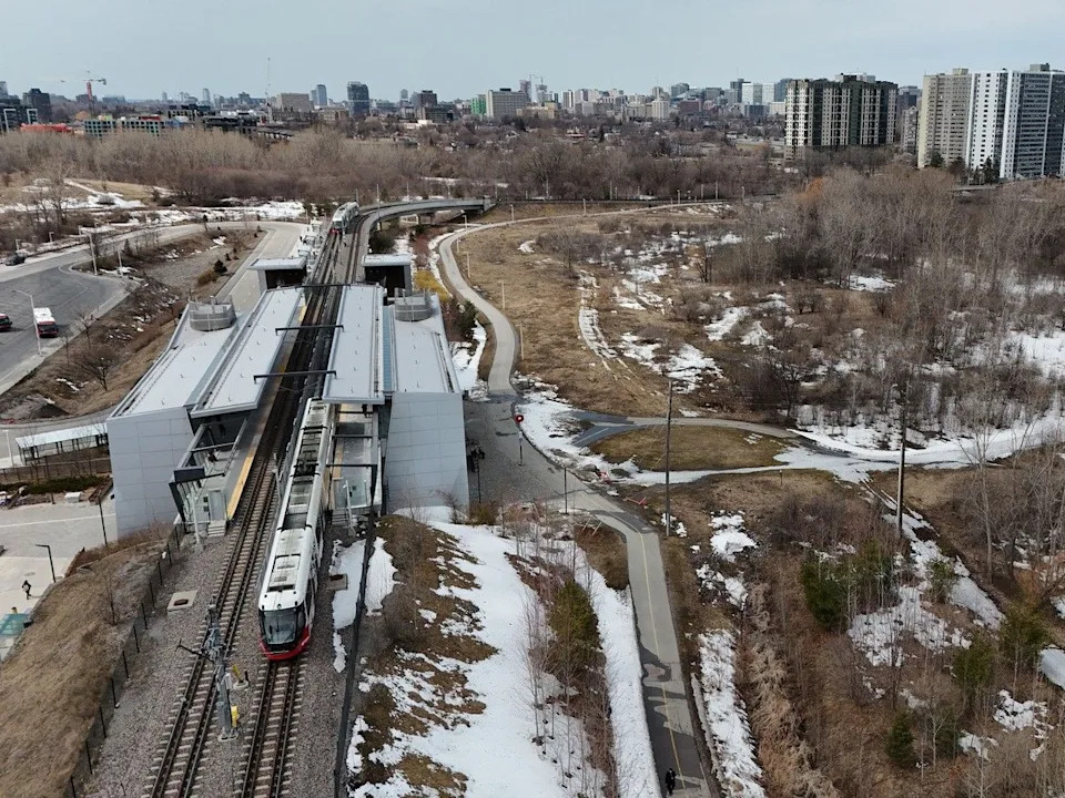An overhead view of a Line 1 train arriving at Hurdman Station.