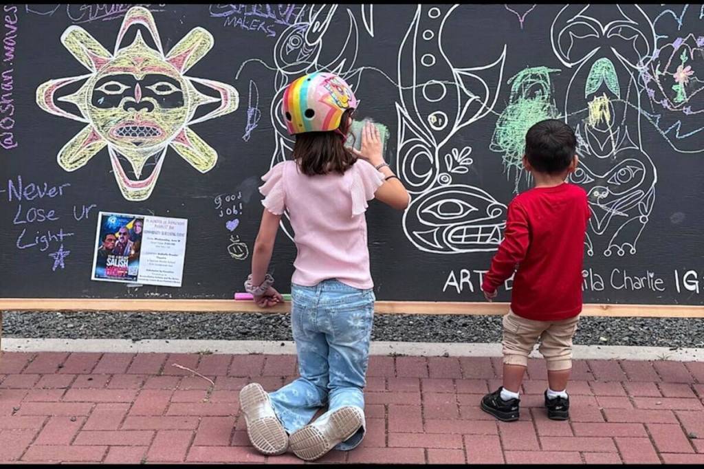 A doodling duo at the festival&rsquo;s giant chalkboard at the annual Change-Makers Gathering Festival in Langford. (Harry Corro/Black Press Media file photo)