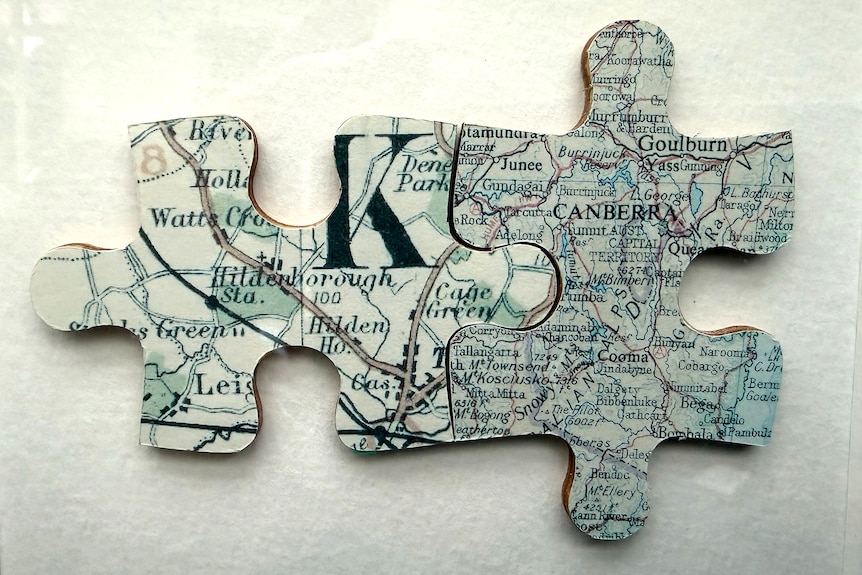 Two maps fashioned into two complementary jigsaw pieces