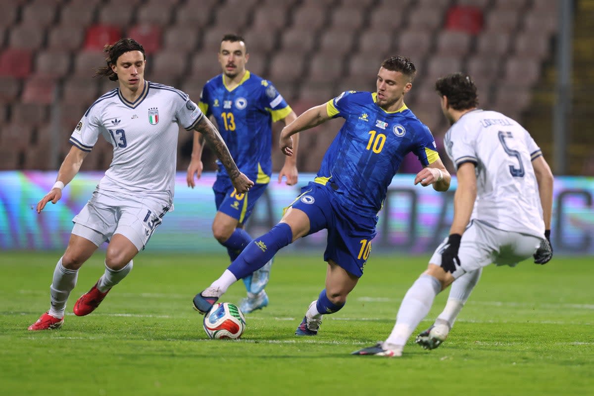 Bosnia and Herzegovina's Ermedin Demirovic in action with Italy's Riccardo Calafiori and Manuel Locatelli (REUTERS)