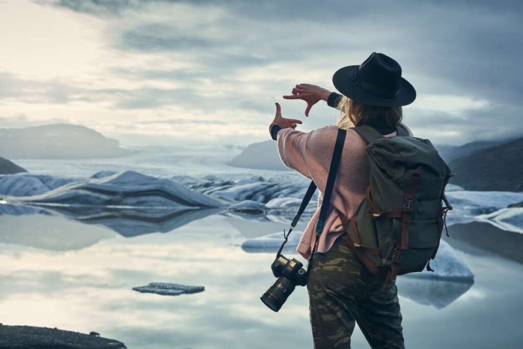 Are you the world’s worst photographer? An Icelandic airline wants to hire you Photographer standing at the edge of an icy lagoon planning photography frame (Representative Image Source: Getty Images | Janiecbros)