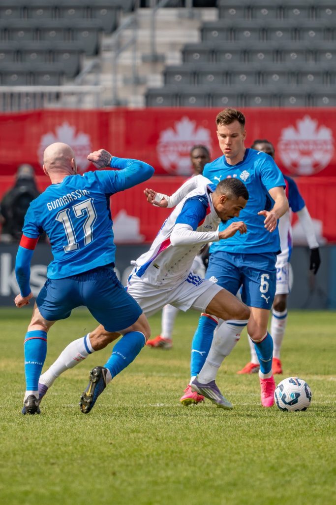 Haiti’s star forward Wilson Isidor is sprinting past two defenders before unleashing a powerful shot for the equalizer in the match against Iceland on Tuesday, March 31, 2026. Photo credit: Haitian Football Federation.
