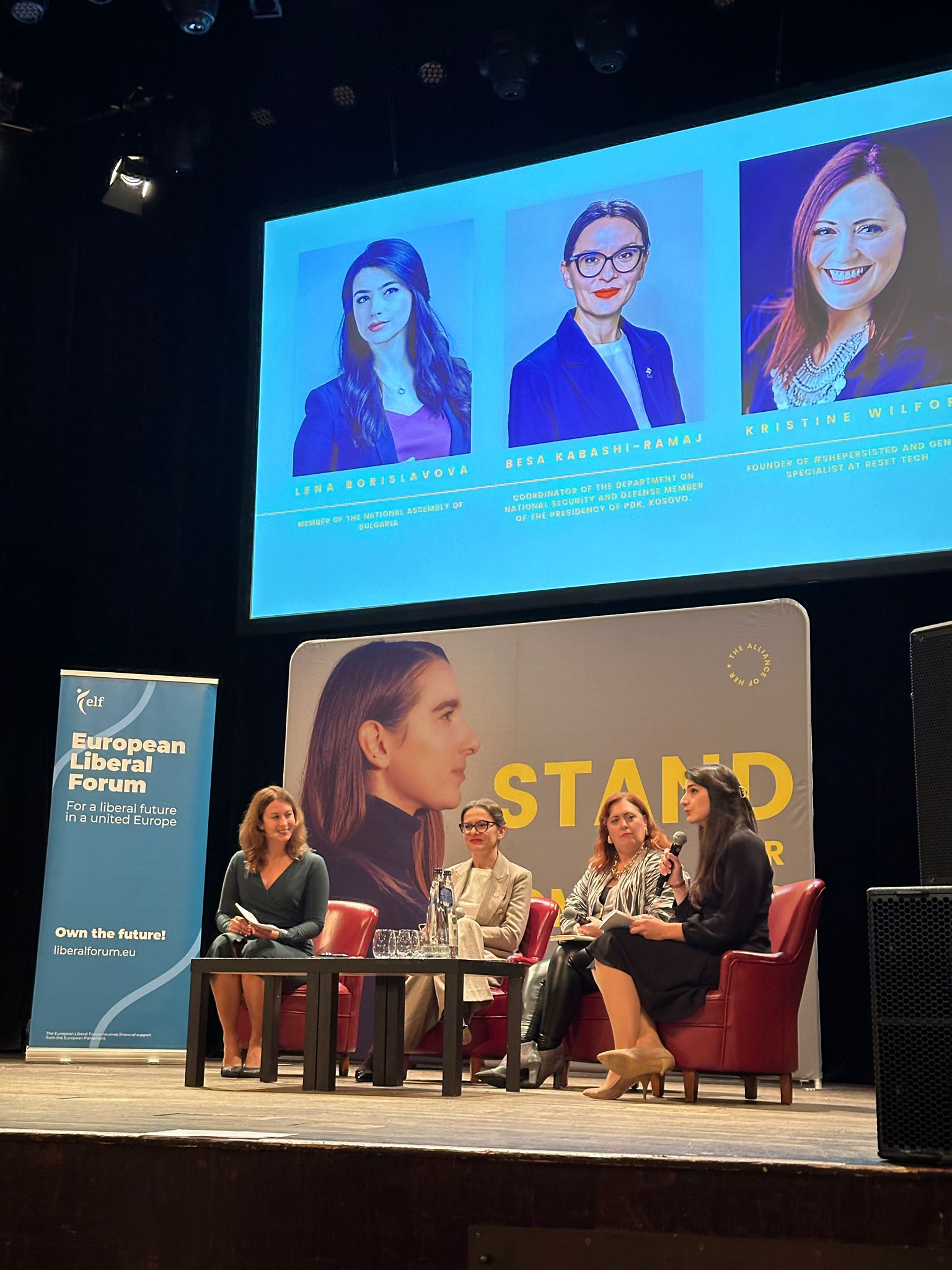 Kabashi on stage at a conference 