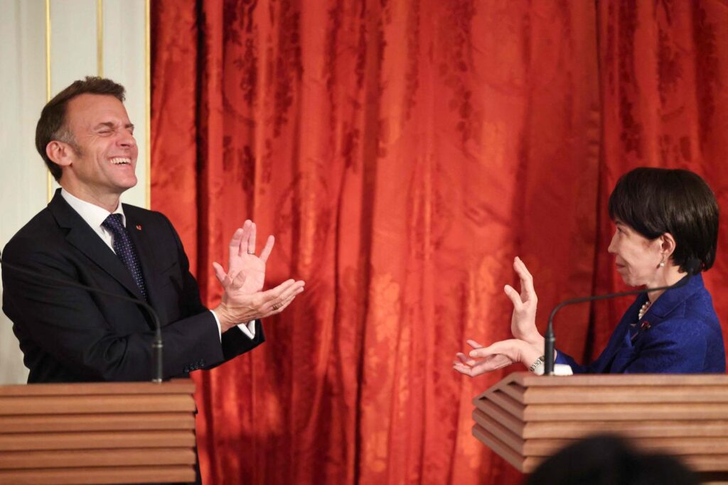 Emmanuel Macron performs a kamehameha with the Japanese Prime Minister