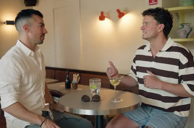 Sam and Filip pictured talking to each other.