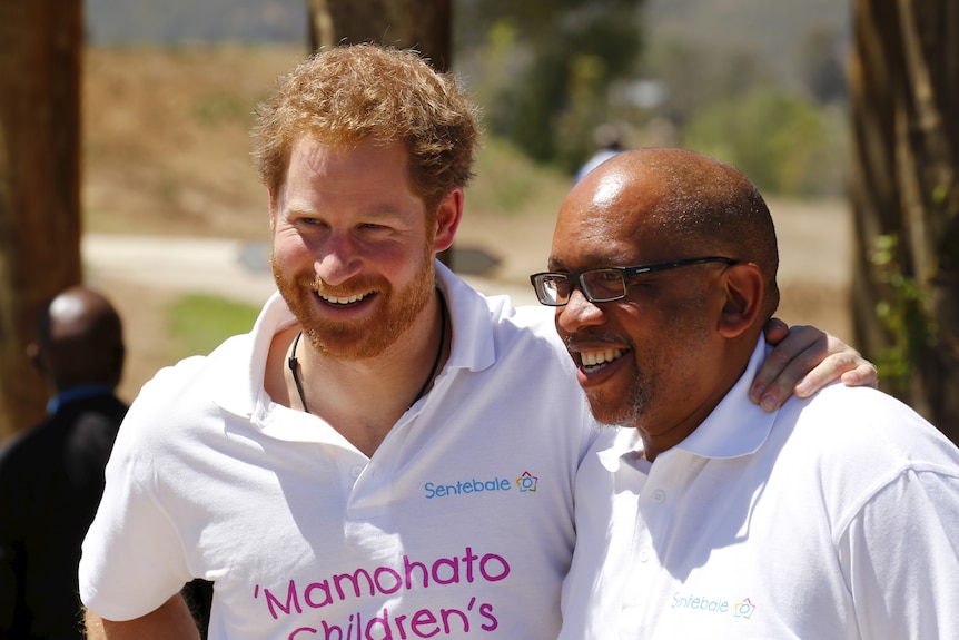 Prince Harry and Prince Seeiso wearing matching Sentebale shirts, smiling