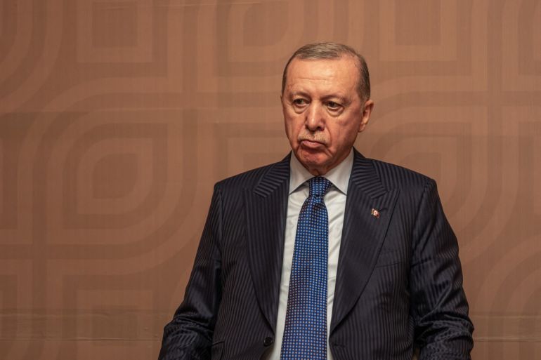 Turkey's President Recep Tayyip Erdogan attends a signing 