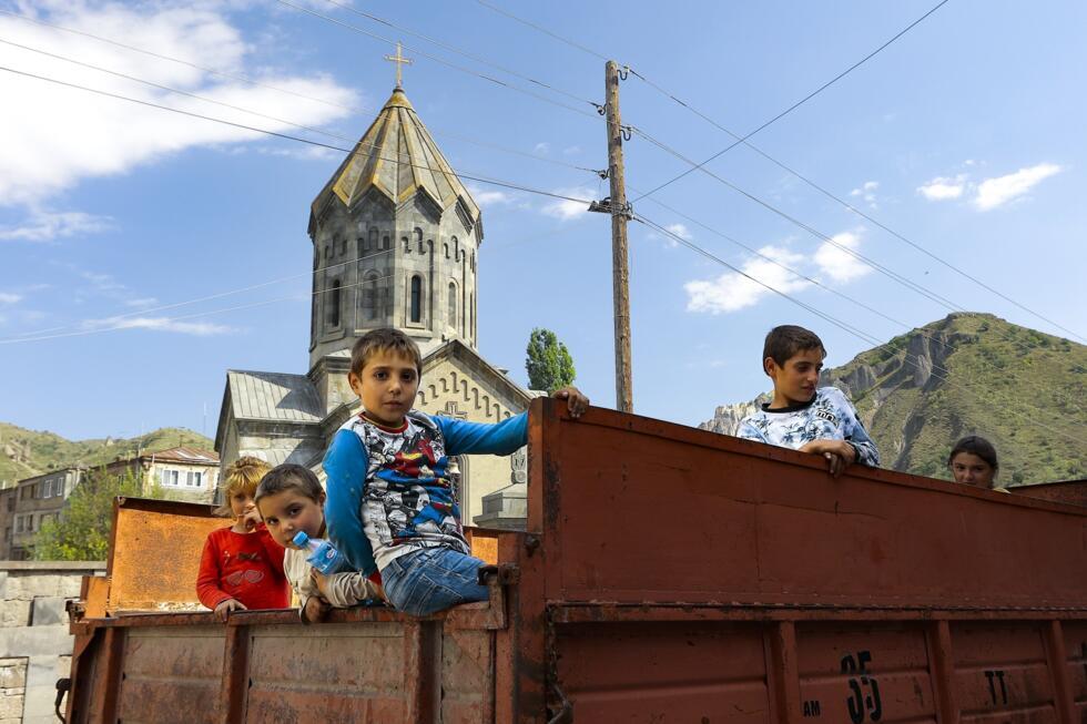 Armenian children from Nagorno-Karabakh look from a truck after arriving in Armenia's Goris in the Syunik region on September 28, 2023