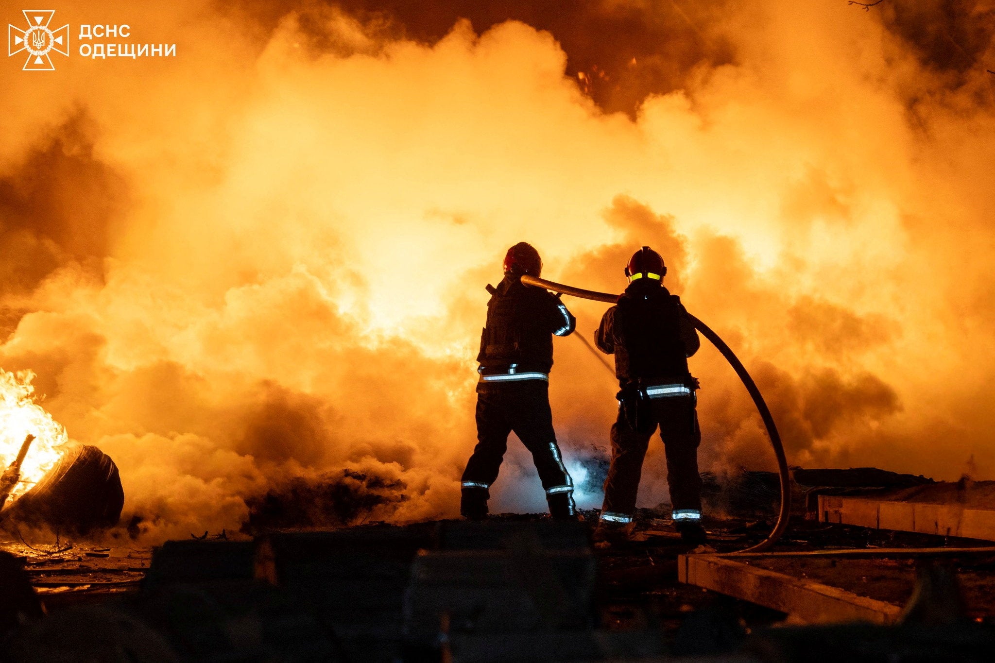 Firefighters work at the site of an overnight Russian drone strike in Odesa on Saturday