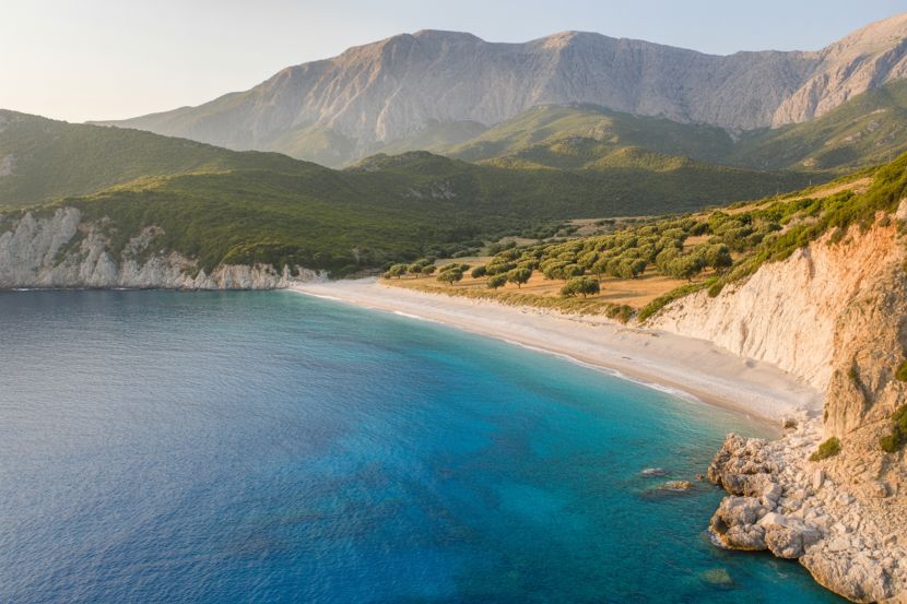 Albania's scenic coastline with clear blue waters and lush green mountains.