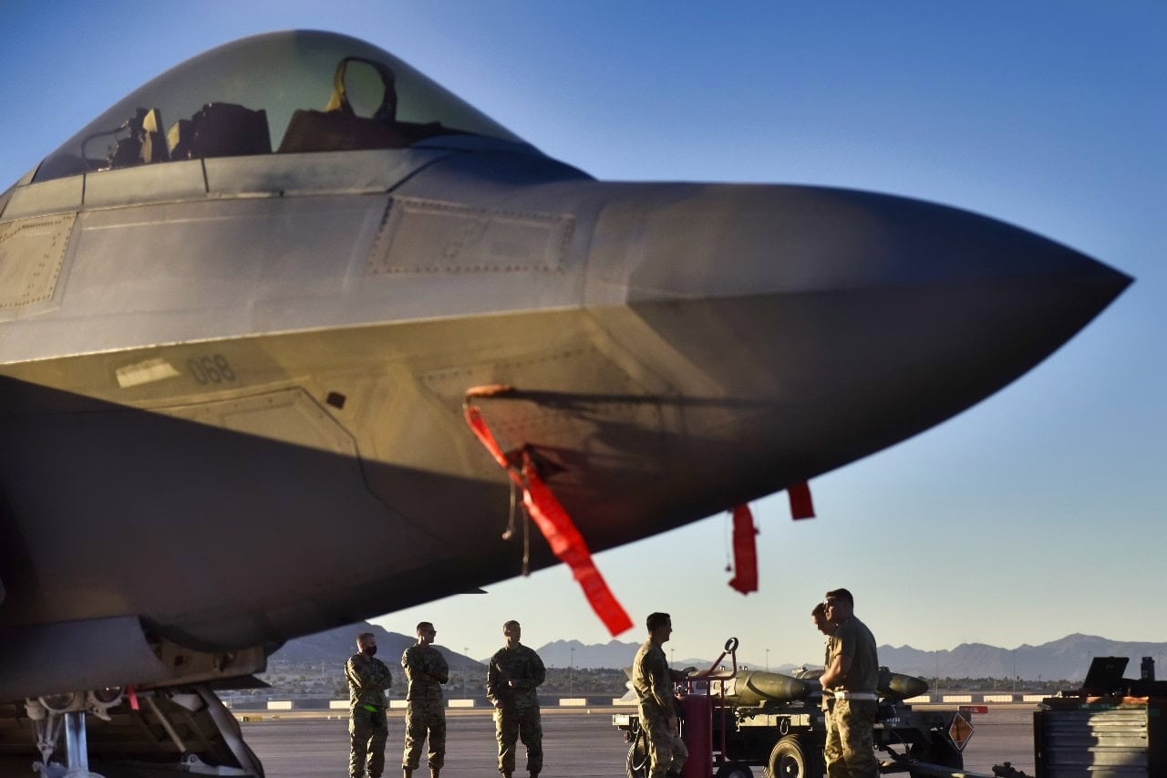 Airmen from the 757th Aircraft Maintenance Squadron talk about their execution plan next to an F-35 Lightning prior to the start of weapons load crew competition at Nellis Air Force Base, Nevada, Oct. 16, 2020. Throughout the year weapons crews are put to the test of safely loading and unloading ordinance to their respective aircraft in front of their peers while being timed. At the end of the year, the winners from each event are pitted against each other to see which team is the best. (U.S. Air Force photo by Tech. Sgt. Alexandre Montes)