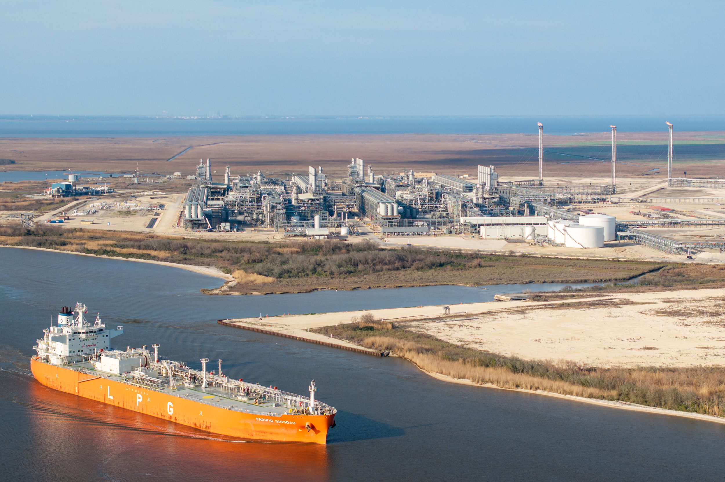 A cargo ship passes the Cheniere Energy liquefied natural gas plant on Feb. 10 in Port Arthur, Texas. Credit: Brandon Bell/Getty Images
