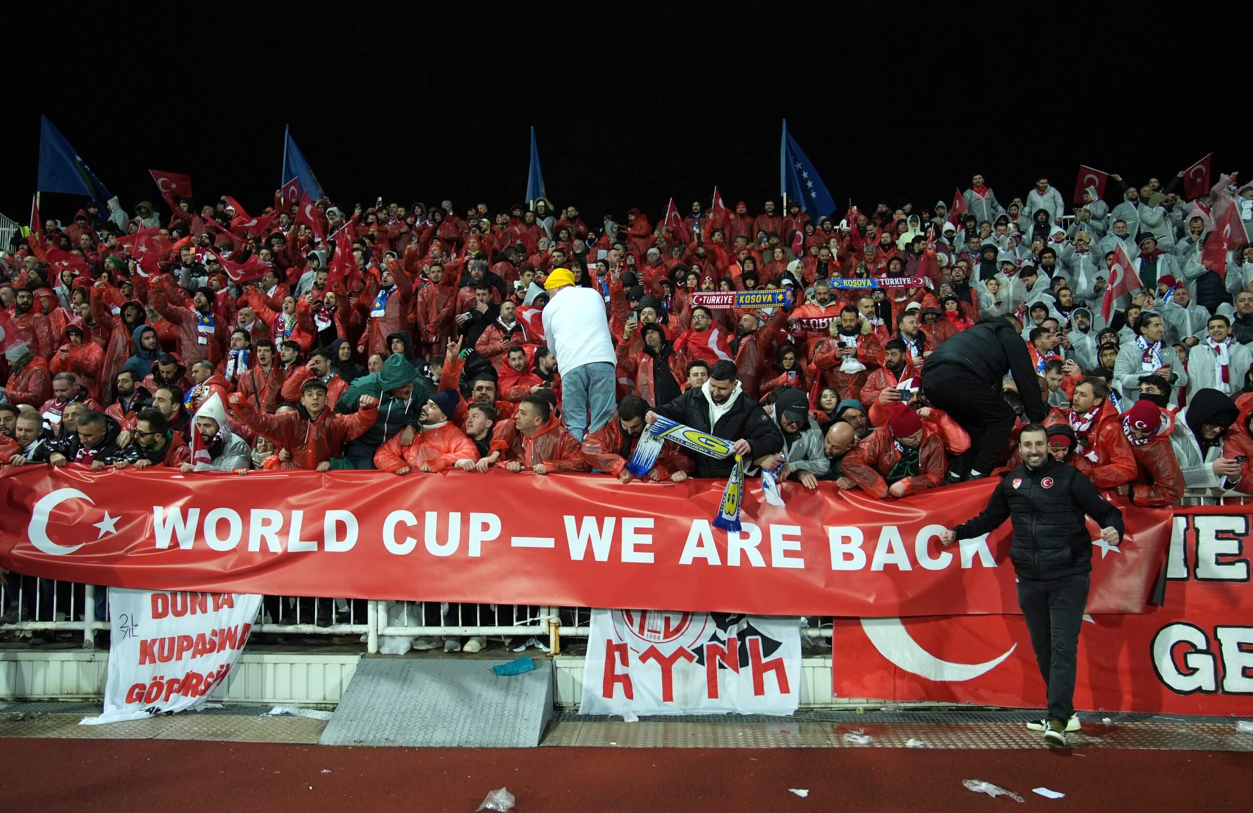 Turkey fans unfurl a banner inside Fadil Vokkri Stadium reading: 'World Cup - we are back'
