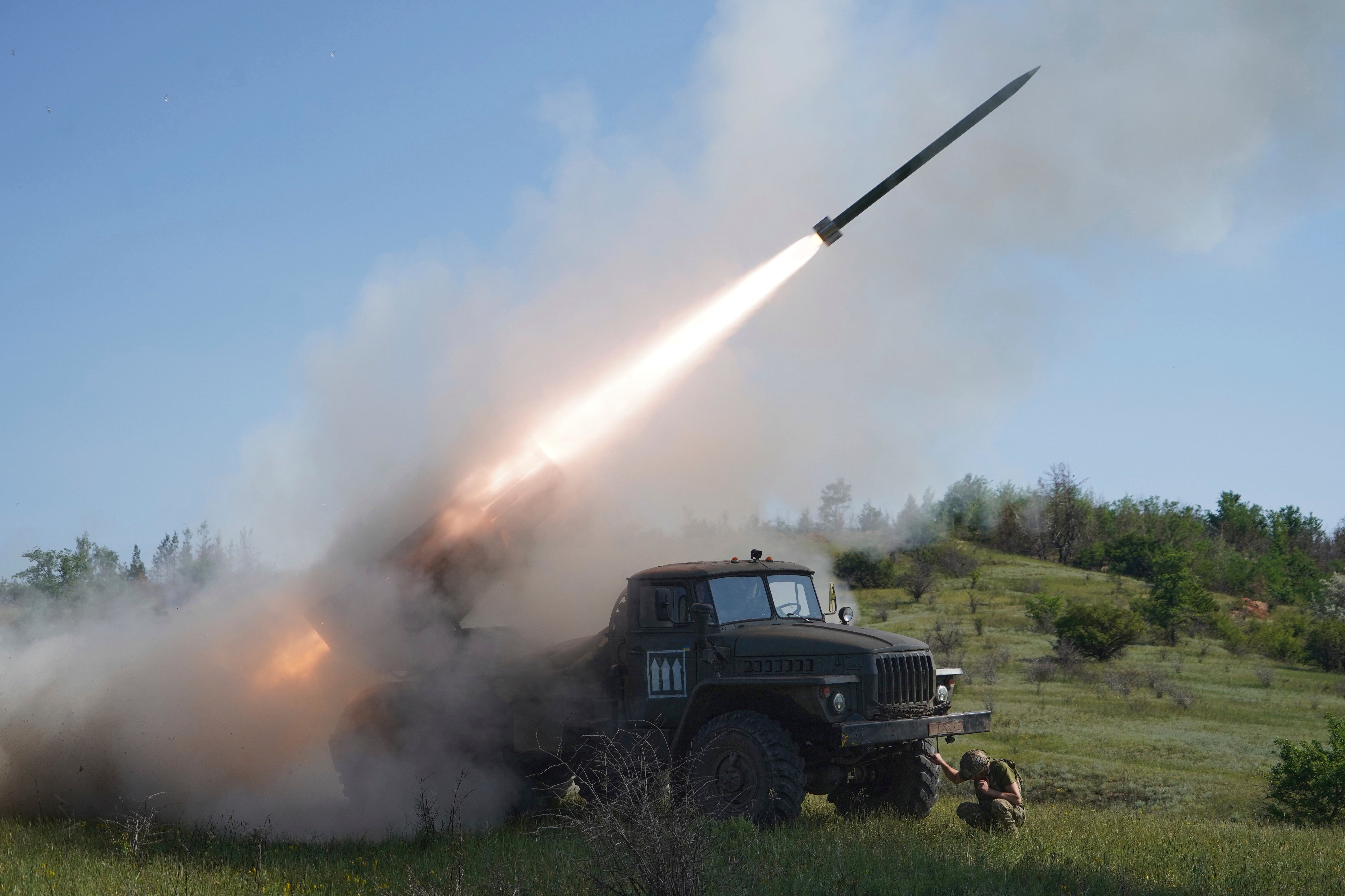 Ukrainian servicemen fire a Grad multiple rocket launcher towards Russian positions on the front line in Donetsk
