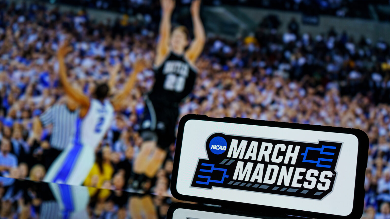 Michigan Wins NCAA Title, Beats UConn 69-63 Kaunas, Lithuania - 2023 March 13: March madness logo on screen and NCAA basketball game play on TV in the background. High quality photo