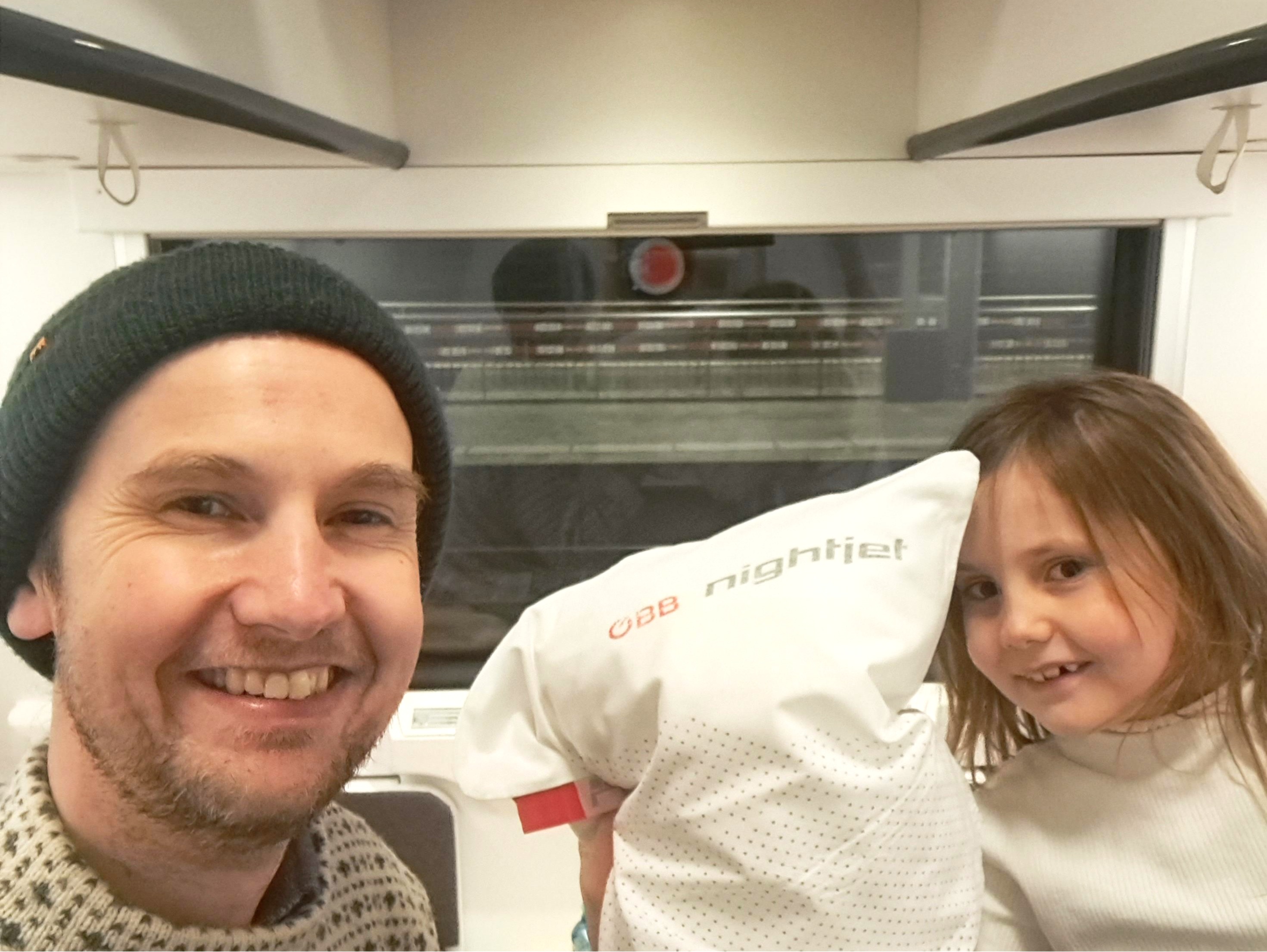 A father and daughter on the night train from Switzerland to Denmark.