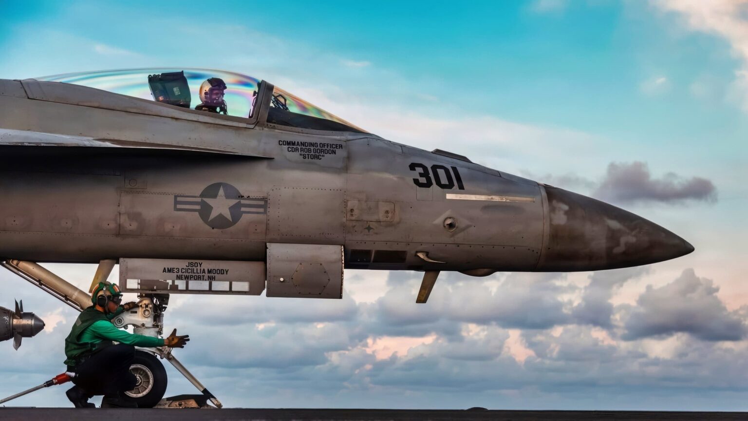 A U.S. Sailor performs a safety scan of the catapult track as an F/A-18E Super Hornet aircraft positions for launch from the flight deck while underway in the Caribbean Sea, Nov. 25, 2025. U.S. military forces are deployed to the Caribbean in support of Operation Southern Spear, the U.S. Southern Command mission, Department of War-directed operations, and the president’s priorities to disrupt illicit drug trafficking and protect the homeland. (U.S. Navy photo)