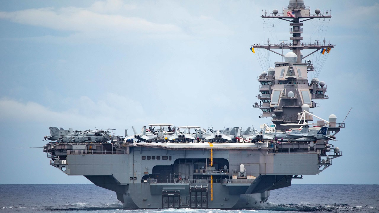 A view of the first-in-class aircraft carrier USS Gerald R. Ford (CVN 78) from aboard the Ticonderoga-class guided-missile cruiser USS Normandy (CG 60) as Normandy participates in a Tactical Force Exercise as part of the Gerald R. Ford Carrier Strike Group, Oct. 13, 2022. Ford is on its inaugural deployment conducting training and operations alongside NATO Allies and partners to enhance integration for future operations and demonstrate the U.S. Navy’s commitment to a peaceful, stable and conflict-free Atlantic region. (U.S. Navy photo by Mass Communication Specialist 2nd Class Malachi Lakey)