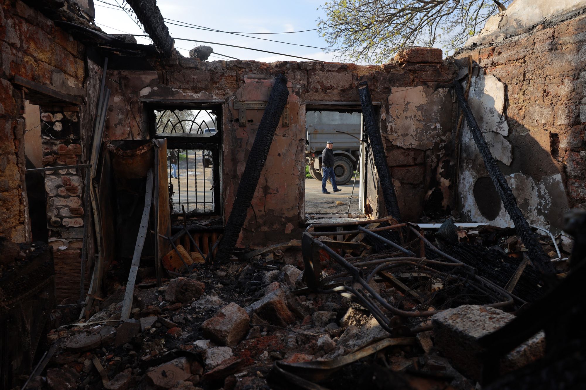 A local resident walks past a destroyed house following an air attack in Odesa on Saturday