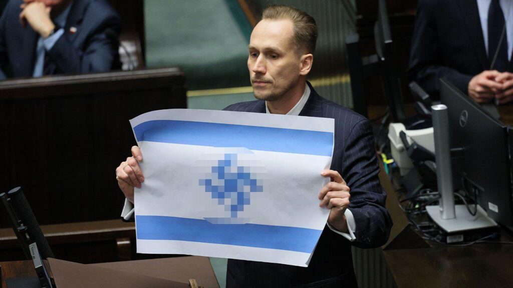 Far-right Polish MP unfurls Israeli flag with swastika in parliament