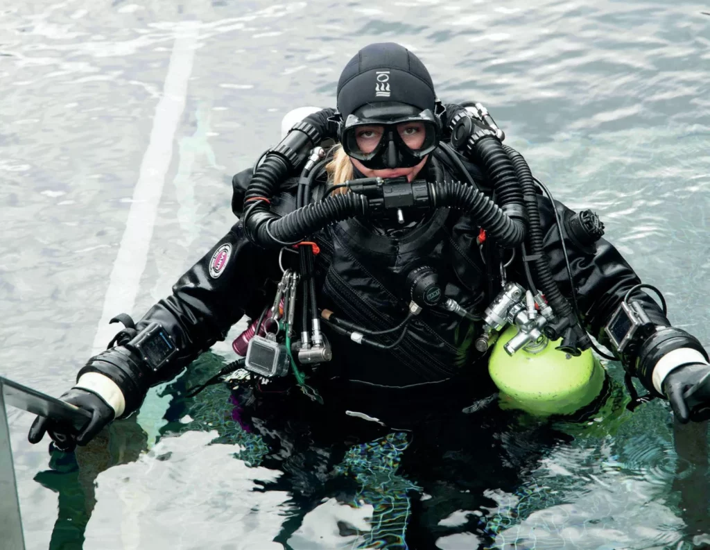 Technical diver Yana Stashkevich in full rebreather gear at the surface before a scientific dive in Iceland.