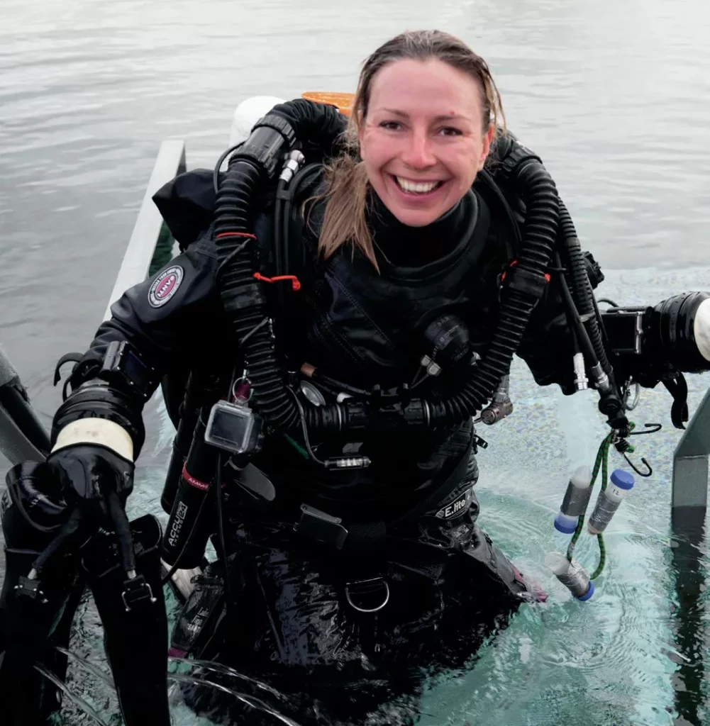 Diver Yana Stashkevich smiling after a successful scientific sampling dive in Iceland.