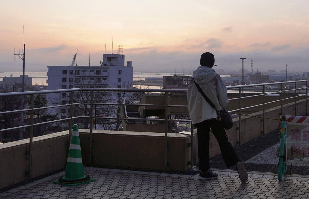 A local resident evacuates to higher ground after a tsunami warning was issued following an earthquake in Kushiro on Hokkaido. Photo: Kyodo/Reuters
