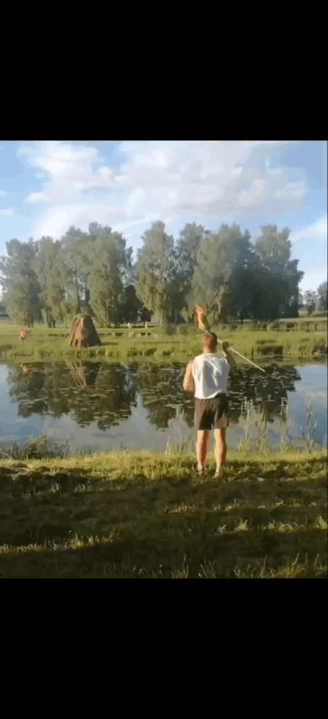 Former world champion in javeline throw, Andrus Värnik, lights a bonfire with a burning javeline