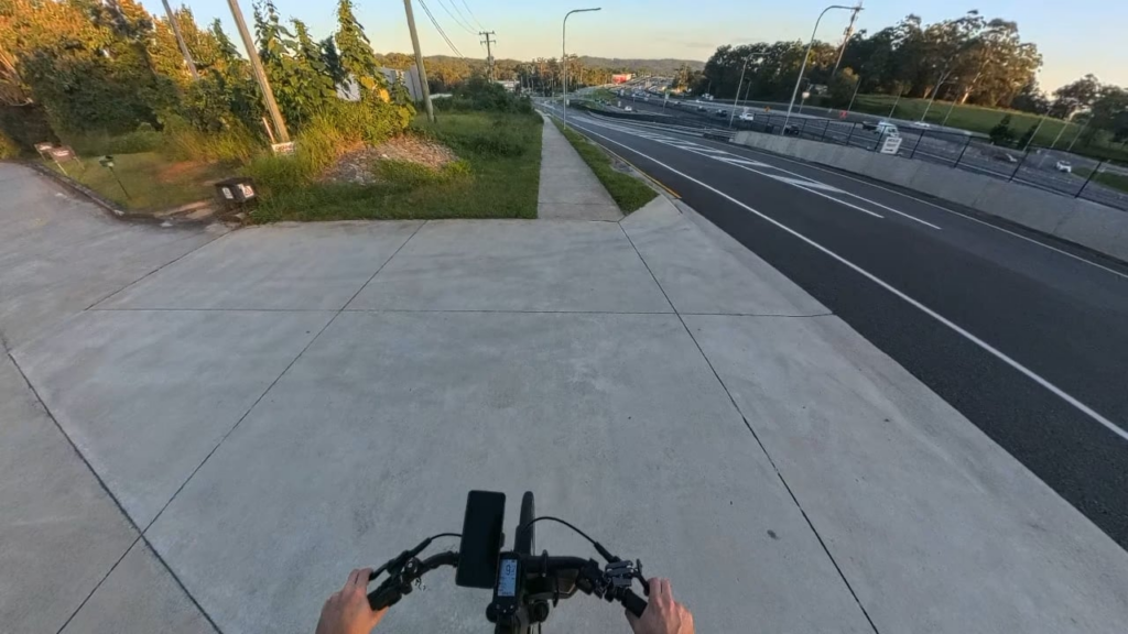 Legal E-bike travelling down a hill legally vs Legal E-bike coasting down the same hill