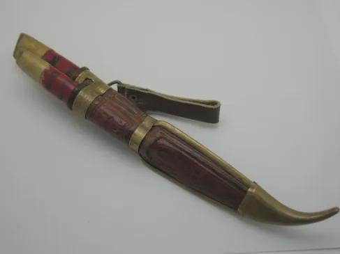 Question about puukkos: how does the brass "stick" to the leather? I see no rivets. Glue? Or just physically fitted tight together? (sexy knife btw)